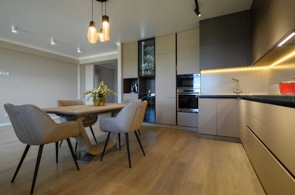 Large modern grey luxurious kitchen and dining room in studio apartment