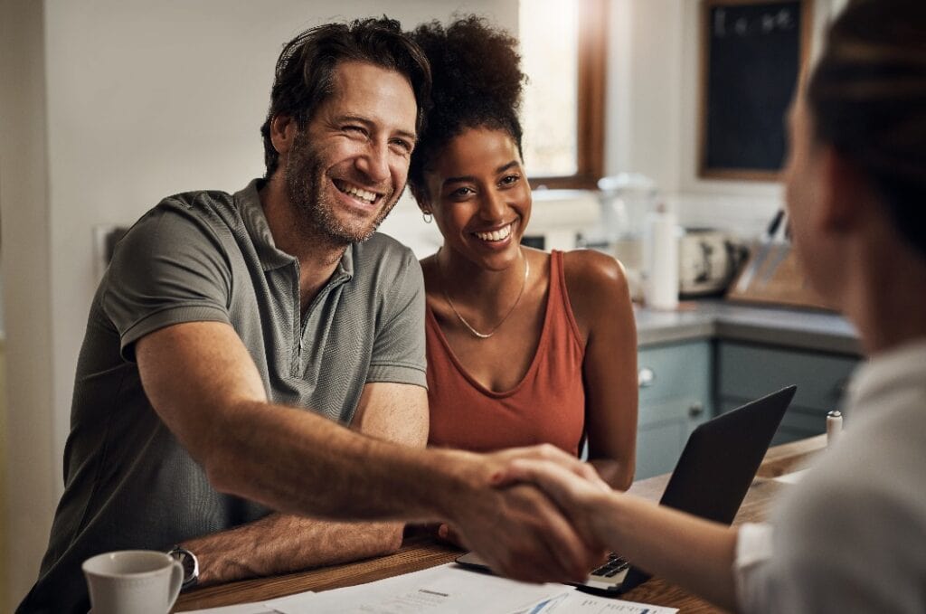 Thank you so much for your assistance. Cropped shot of a handsome middle aged man shaking hands with a financial advisor during a consultation at home.